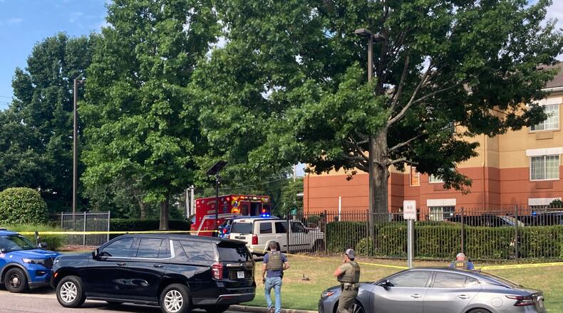 Law enforcement officers work the scene after a federal agent with the Memphis Safe Task Force shot and killed a person at a hotel in Memphis, Tenn., on Wednesday, July 8, 2026. (Natalie Van Gundy/Daily Memphian via AP)