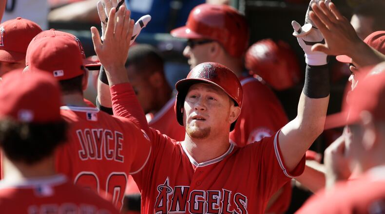 FILE - In this Oct. 3, 2015, file photo, Los Angeles Angels' Kole Calhoun celebrates with teammates after hitting a solo home run during the ninth inning of a baseball game against the Texas Rangers, in Arlington, Texas. Gold Glove right fielder Kole Calhoun has avoided an arbitration hearing with the Angels, agreeing to a $3.4 million, one-year contract. (AP Photo/LM Otero), File