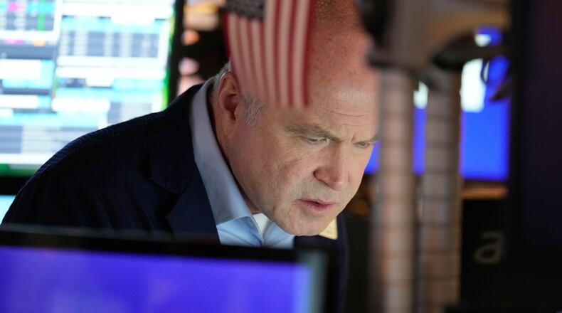 Derek Orth works on the floor at the New York Stock Exchange in New York, Wednesday, Dec. 10, 2025. (AP Photo/Seth Wenig)