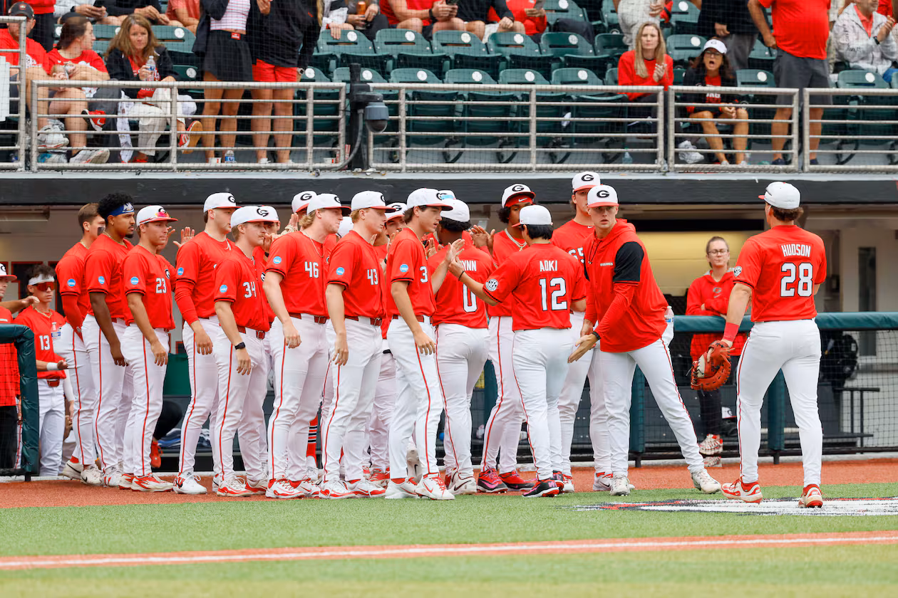 Georgia Bulldogs pitcher Caden Aoki receives high-fives after finishing the fifth inning of Sunday's NCAA Regional final game. (Miguel Martinez/AJC)