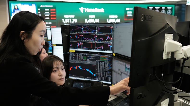Currency traders watch monitors at the foreign exchange dealing room of the Hana Bank headquarters in Seoul, South Korea, Monday, April 6, 2026. (AP Photo/Ahn Young-joon)