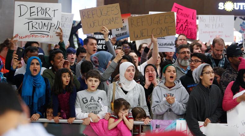 Protesters demonstrate againt Muslim immigration ban on Saturday, Jan. 28, 2017 at Dallas Fort-Worth Airport.