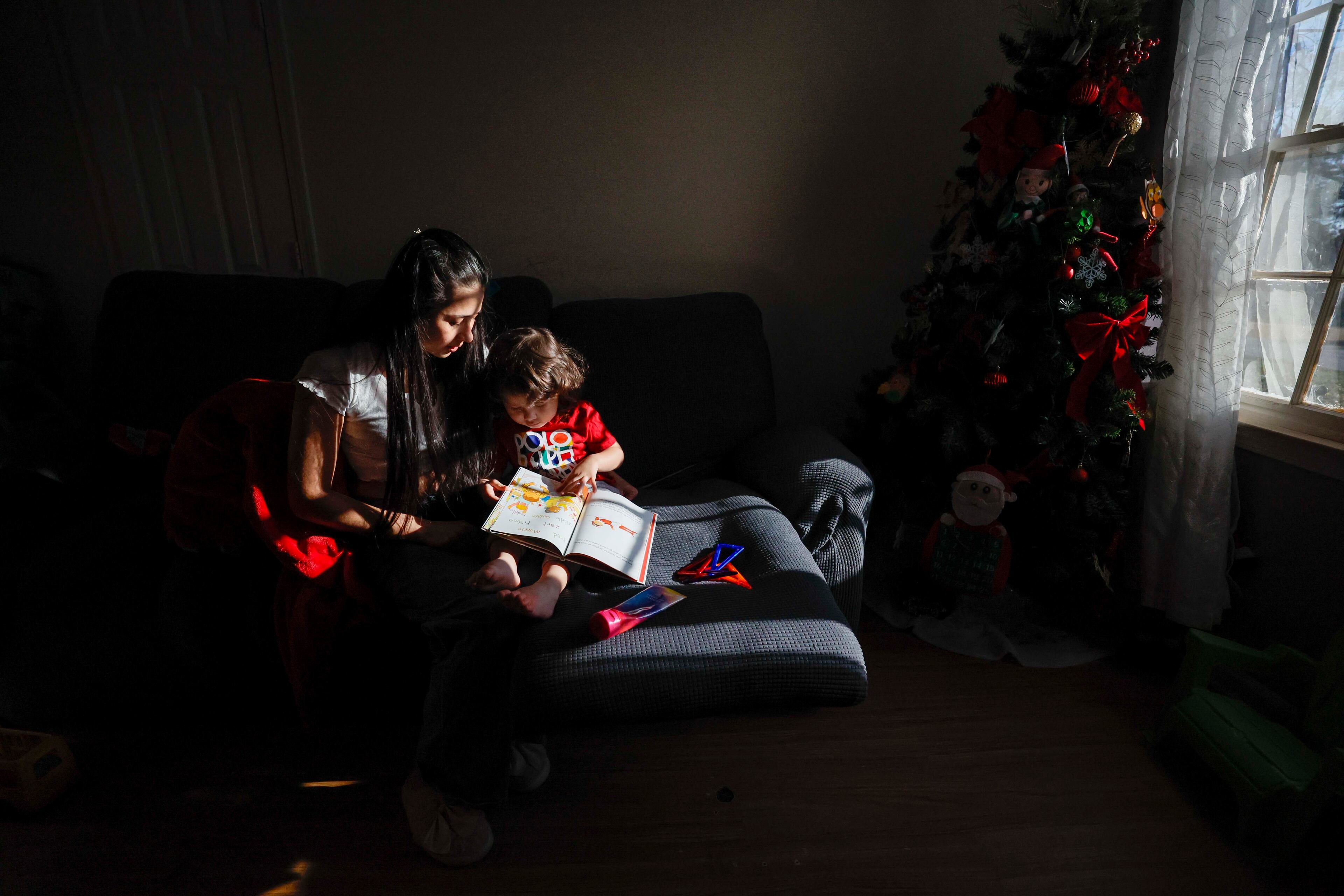 Ceudy Gutierrez reads a book to her 2-year-old son, Matias (2), at their home in Buford, GA, on Tuesday, Nov. 18, 2025. Ceudy Gutierrez is struggling to make ends meet for herself and her three young kids following her husband’s ICE arrest earlier this fall.
(Miguel Martinez/ AJC)