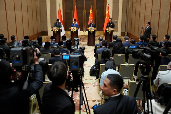 Indonesian Defense Minister Sjafrie Sjamsoeddin, left, Foreign Minister Sugiono, center left, Chinese Foreign Minister Wang Yi, center right, and Defense Minister Dong Jun attend a press briefing after the first meeting of China-Indonesia joint foreign and defense ministerial dialogue at the Diaoyutai State Guest House Monday, April 21, 2025 in Beijing, China. (Iori Sagisawa/Pool Photo via AP)