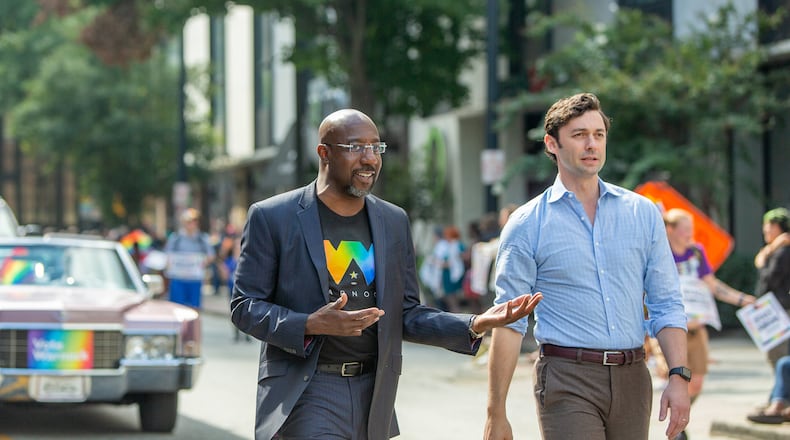 U.S. Sens. Raphael Warnock, left, and Jon Ossoff, shown participating in October in Atlanta's Pride Parade, voted in favor of advancing a bill to create a federal law protecting the rights of consenting adults to wed. (Jenni Girtman for The Atlanta Journal-Constitution)