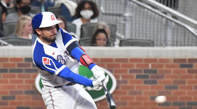 April 9, 2021 Atlanta - Atlanta Braves catcher Travis d'Arnaud (16) hits hits an RBI single in the 5th inning at Truist Park on Friday, April 9, 2021. Atlanta Braves won 8-1 over Philadelphia Phillies. (Hyosub Shin / Hyosub.Shin@ajc.com)
