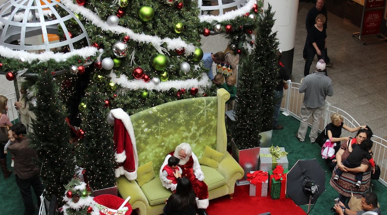 Shoppers at Lenox Square during a visit and photo session with Santa. Lenox and many other local malls also offer sessions with Santa designed specifically for kids with autism and other special needs. (SIMON MALLS)