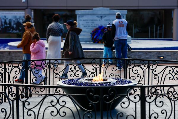 Visitors walk past the eternal flame at the King Center as others visit the tomb of Martin Luther King Jr. and Coretta Scott King at the Martin Luther King Jr. National Historic Site on Sunday, Jan. 18, 2026. (Miguel Martinez/AJC)
