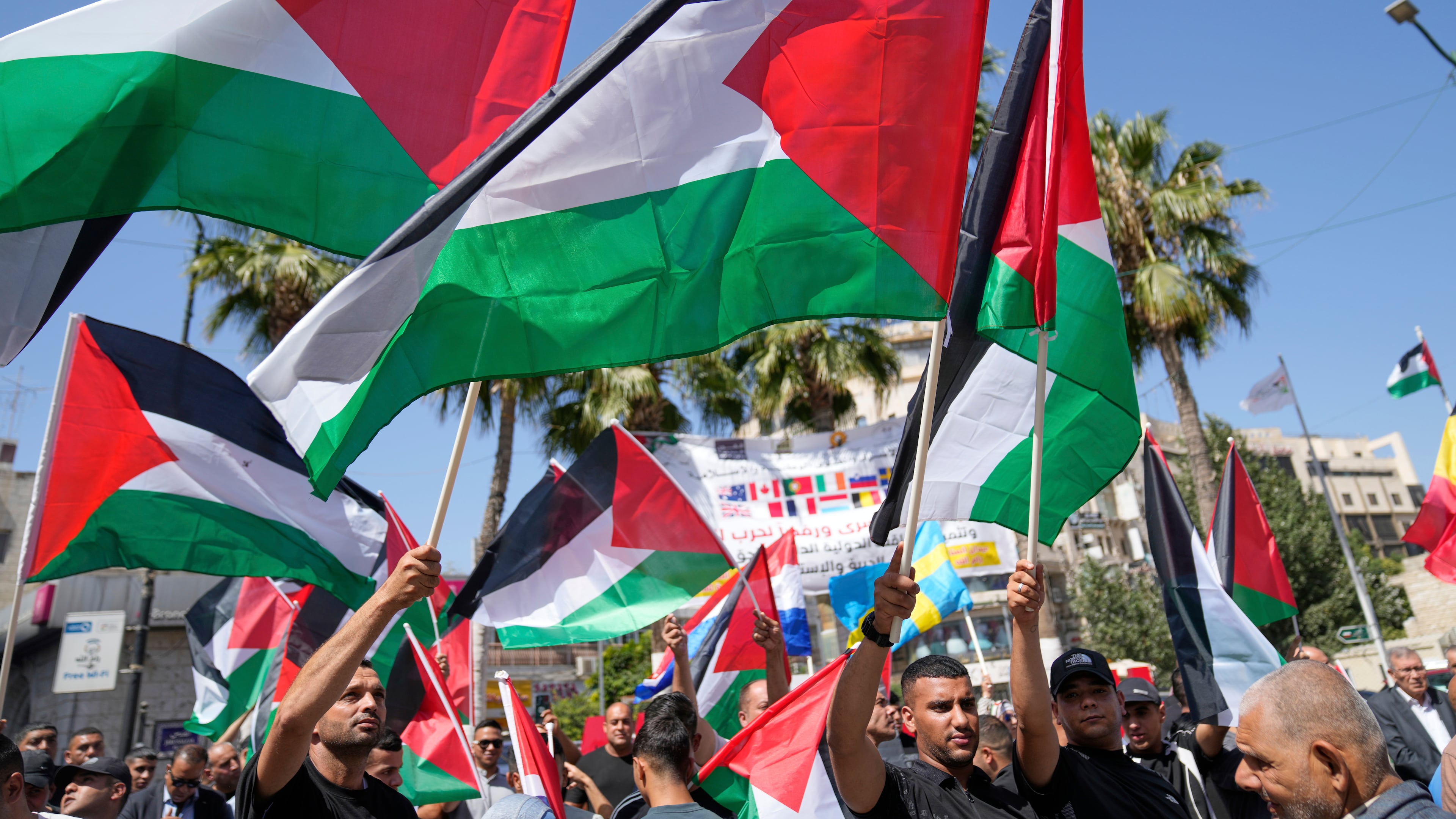 Palestinians fly their flags during a rally in support for Gaza and celebrating the latest western nations recognitions of the Palestinian state ahead of the United Nations General Assembly meetings, in the West Bank city of Ramallah Tuesday, Sept. 23, 2025. (Nasser Nasser/AP)