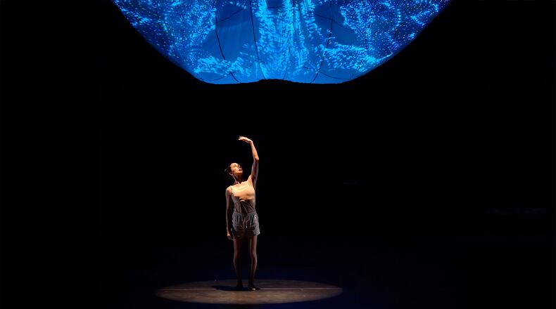 In "Step the Brain Along a Path," Terminus Modern Ballet Theatre's Rachel Van Buskirk moves beneath a glowing projection design based on brain imaging.
Courtesy of Felipe Barral