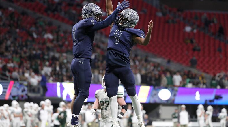 Eagle's Landing Christian wide receiver Sean Queen (7) celebrates his receiving touchdown with quarterback Nate McCollum (4) in the second half of the Class A Private Championship against Athens Academy Friday, Dec. 8, 2017,  at Mercedes-Benz Stadium in Atlanta.