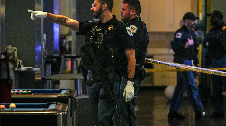 Cobb County officers were investigating a shooting at Main Event late Sunday. Two people were shot and the alleged shooter remains on the run, according to police.