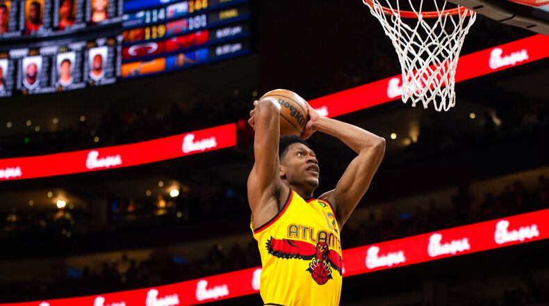 Atlanta Hawks forward De'Andre Hunter (12) scores during the first half of an NBA basketball game against the Brooklyn Nets, Saturday, April 2, 2022, in Atlanta. (AP Photo/Hakim Wright Sr.)