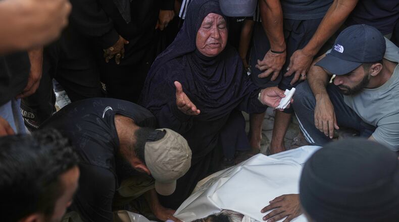 Relatives and friends grieve over the body of Hassan Qahman at a hospital morgue after he was killed in an Israeli airstrike in Gaza City, Saturday, Aug. 1, 2026. (AP Photo/Jehad Alshrafi)