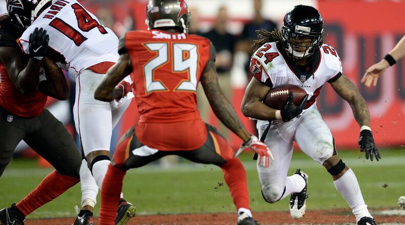 Atlanta Falcons running back Devonta Freeman (24) cuts in front of Tampa Bay Buccaneers cornerback Ryan Smith (29) during the second half of an NFL football game Monday, Dec. 18, 2017, in Tampa, Fla. (AP Photo/Jason Behnken)