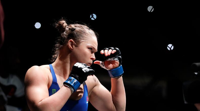 FILE - Ronda Rousey holds up her hands before her women's bantamweight championship mixed martial arts bout with Amanda Nunes at UFC 207, Dec. 30, 2016, in Las Vegas. (AP Photo/John Locher, File)