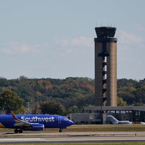 A plane taxis past the control tower before takeoff at the Nashville International Airport, Friday, Oct. 31, 2025, in Nashville, Tenn. (AP Photo/George Walker IV)