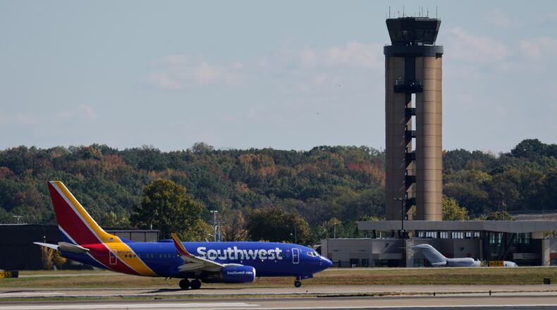A plane taxis past the control tower before takeoff at the Nashville International Airport, Friday, Oct. 31, 2025, in Nashville, Tenn. (AP Photo/George Walker IV)