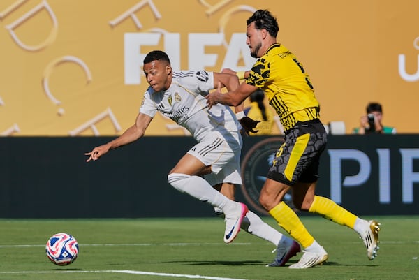 Real Madrid's Kylian Mbappe controls the ball against Borussia Dortmund's Ramy Bensebaini during the second half of a Club World Cup quarterfinal soccer match, Saturday, July 5, 2025 in East Rutherford, N.J. (AP Photo/Frank Franklin II)