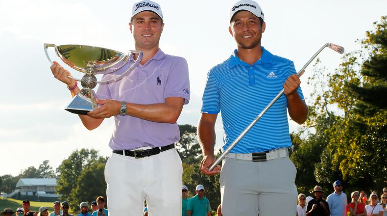 It's a slightly awkward end to the 2017 Tour Championship when Justin Thomas, left, and Xander Schauffele share the stage with two different trophies. (Kevin C. Cox/Getty Images)
