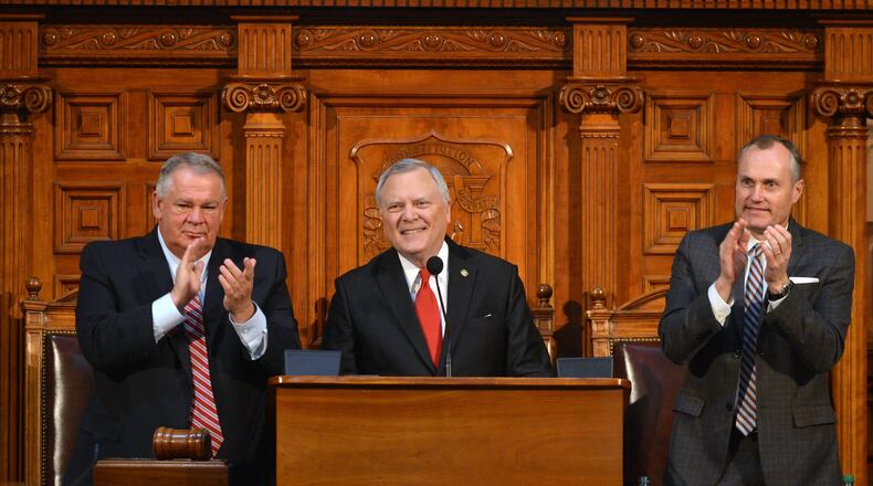 House Speaker David Ralston, left, and Lt. Gov. Casey Cagle give Gov. Nathan Deal a stand ovation during his state of the state address in the House Chambers Wednesday January 15, 2014. BRANT SANDERLIN /BSANDERLIN@AJC.COM
