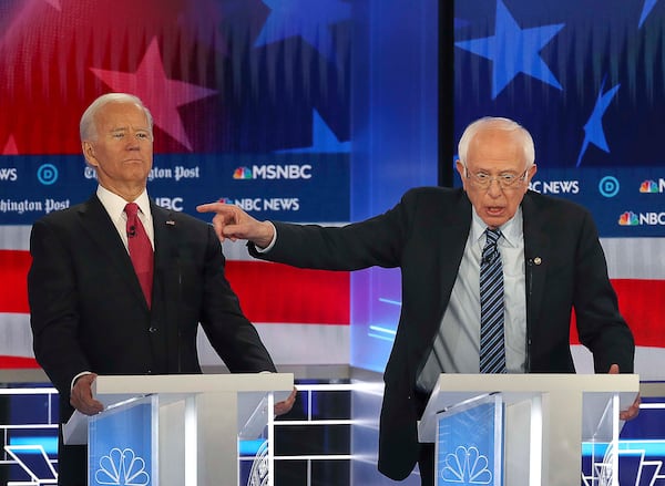 Former Vice President Joe Biden (left) clears the way for Senator Bernie Sanders (center) to make a point, during the MSNBC/The Washington Post Democratic Presidential debate inside the Oprah Winfrey Soundstage at Tyler Perry Studios last November.  Biden and Sanders are the last two major candidates remaining in the race for the Democratic Party nomination. (Alyssa Pointer/Atlanta Journal Constitution)