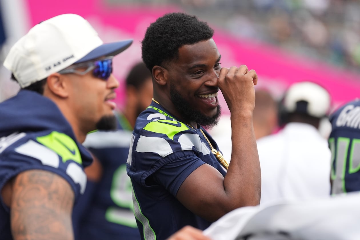 Seattle Seahawks cornerback Devon Witherspoon interacts with teammates on the sideline in the first half of an NFL preseason football game against the Dallas Cowboys, Saturday, Aug. 15, 2026, in Seattle. (AP Photo/Lindsey Wasson)