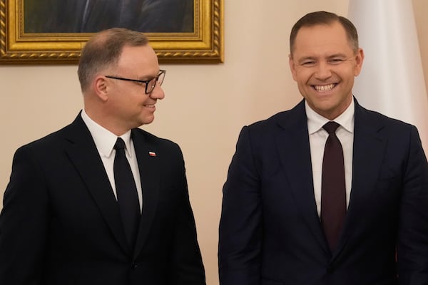 Poland's outgoing President Andrzej Duda, left, welcomes the President Elect Karol Nawrocki at the Presidential Palace in Warsaw, Poland, Tuesday, June 3, 2025. (AP Photo/Czarek Sokolowski)