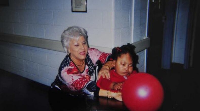 Christen Gordon plays with her special education teacher at Central State Hospital, Faye Smith, a former state lawmaker.