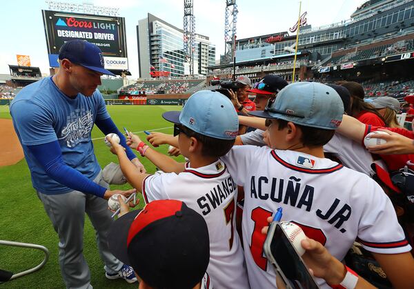 Braves first baseman Freddie Freeman signs autographs for fans during batting practice.    “Curtis Compton / Curtis.Compton@ajc.com”
