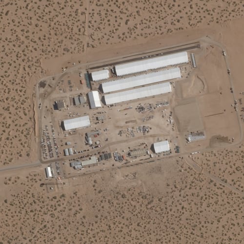 FILE - This Aug. 7, 2025, satellite image shows construction of large white tents for a new immigrant detention center at Fort Bliss, a U.S. Army base outside El Paso, Texas. (Planet Labs via AP, File)