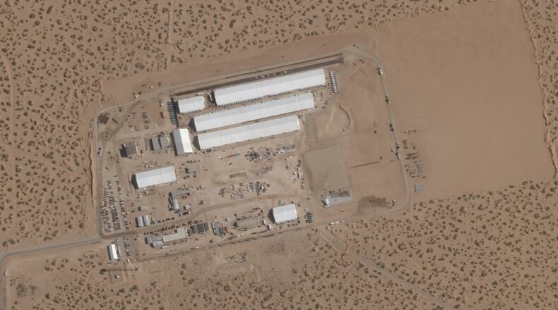 FILE - This Aug. 7, 2025, satellite image shows construction of large white tents for a new immigrant detention center at Fort Bliss, a U.S. Army base outside El Paso, Texas. (Planet Labs via AP, File)