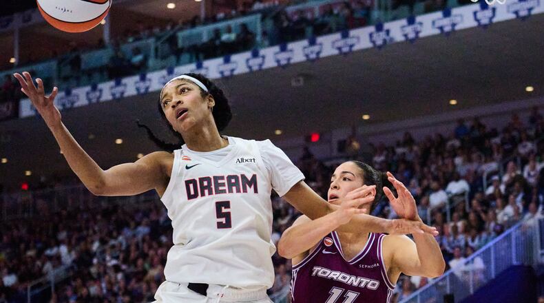 Atlanta Dream's Angel Reese (5) wins a rebound against Toronto Tempo's Kia Nurse, right, during the first half of a WNBA basketball game in Toronto, Friday, July 17, 2026. (Sammy Kogan/The Canadian Press via AP)