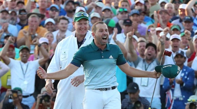 Sergio Garcia lets the world knows how he feels after sinking his birdie putt on the first playoff hole Sunday to win the Masters. (Curtis Compton/ccompton@ajc.com)