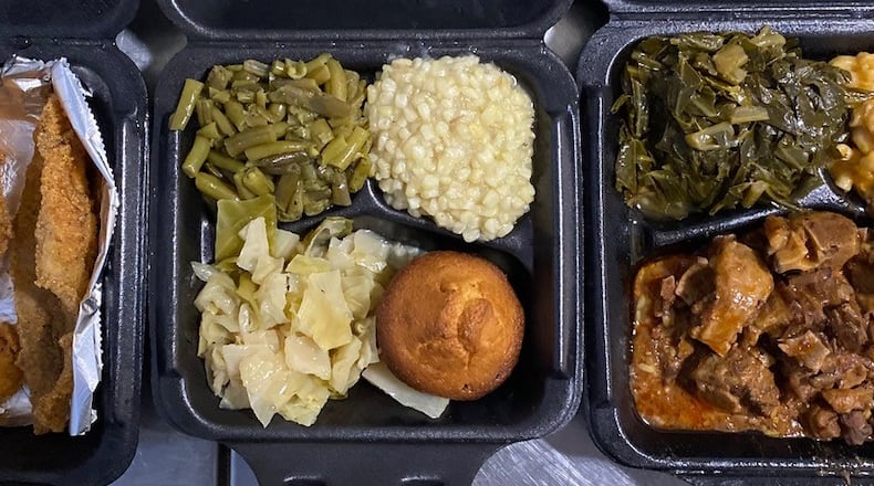 Who’s Got Soul Southern Cafe has locations in Lawrenceville and Decatur. This takeout order from the Decatur store includes a seafood platter with catfish, whiting, shrimp and hushpuppies; a vegetable plate with green beans, corn, cabbage and a corn muffin; and oxtails over rice with macaroni and cheese and collards.
Wendell Brock for The Atlanta Journal-Constitution