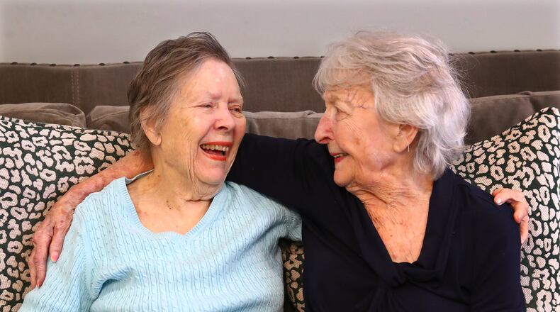 High school friends Elizabeth Carter (left) and Shirley Jones, both 96, share a laugh at their Park Springs assisted living facility in Stone Mountain on Dec 15, 2021. Jones and Carter graduated from Girls High School in Atlanta in 1943. This fall, the women rekindled their friendship after they unexpectedly became neighbors. Curtis Compton / Curtis.Compton@ajc.com