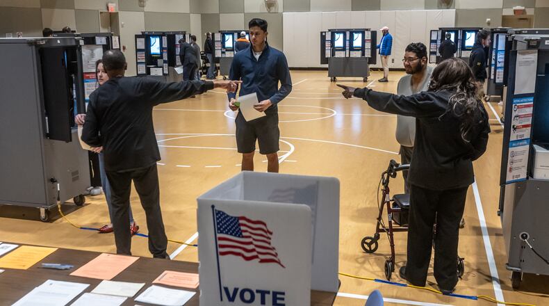 Poll workers direct voters at the Don And Mary Ellen Harp Student Center  in Atlanta. on Tuesday, Nov. 5, 2024 on Election Day. A judge has dismissed a Republican lawsuit that sought to force Fulton County to hire more Republican poll workers for the election. (File photo by John Spink/AJC)