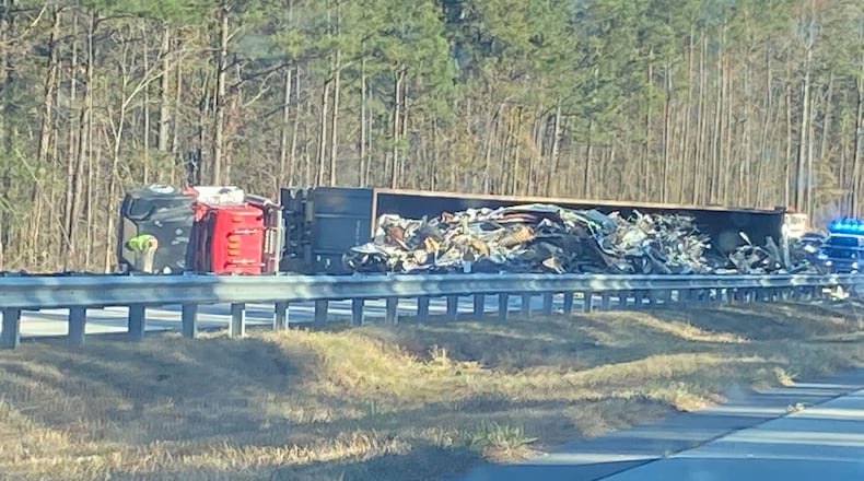 An overturned tractor-trailer is blocking the southbound lanes of Ga. 400 in Forsyth County.