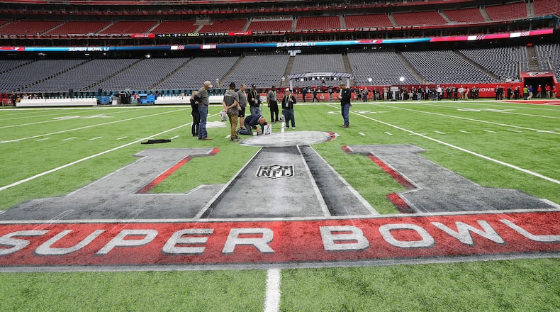 Ed Mangan, of Atlanta, puts the finishing touch on the field for the start of the Super Bowl in NRG Stadium on Sunday, Feb. 5, 2017, in Houston.