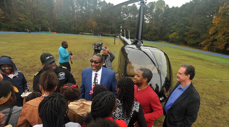 DeKalb Country Schools Superintendent Steve Green (right) and Captain Barrington Irving of The Flying Classroom and Experience Aviation talk with Stone Mountain Middle School students. KENT D. JOHNSON/KDJOHNSON@AJC.COM