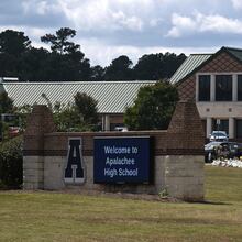 A sign is displayed outside Apalachee High School, Thursday, September 19, 2024, in Winder, about two weeks after two students and two teachers were killed in a shooting inside the school. (Hyosub Shin / AJC)