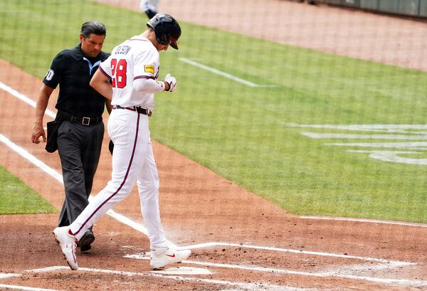 Atlanta Braves' Matt Olson (28) touches home plate after his two-run home run against the Minnesota Twins during the first inning of a baseball game Saturday, April 20, 2025, in Atlanta. (AP Photo/John David Mercer)