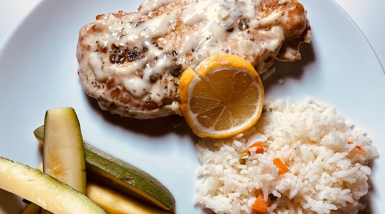 Chicken piccata with basmati rice, zucchini, lemon beurre blanc and capers from Ziba's Restaurant in Grant Park. Bob Townsend/For the AJC
