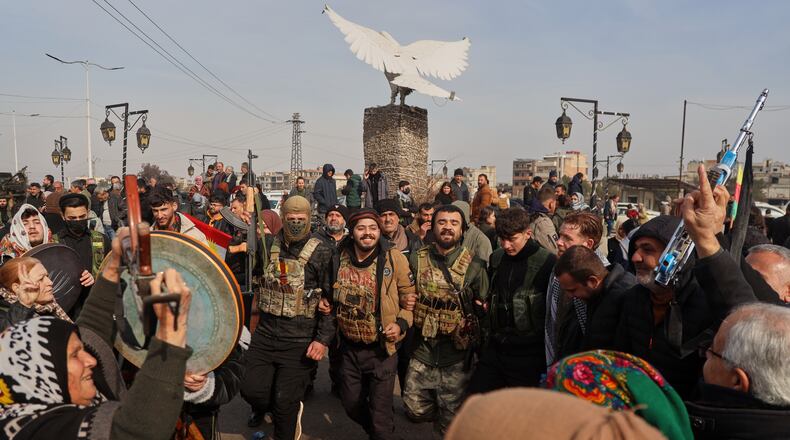 Kurdish fighters with the Syrian Democratic Forces (SDF) are cheered by local residents ahead of the end of a four-day truce with the Syrian government in Hassakeh, northeastern Syria, Saturday, Jan. 24, 2026. (AP Photo/Baderkhan Ahmad)