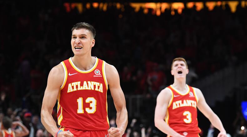 Hawks Bogdan Bogdanovic (left) and Kevin Huerter celebrate during a win over the Heat. (Hyosub Shin / Hyosub.Shin@ajc.com)