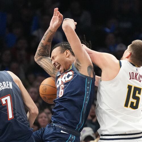 Oklahoma City Thunder forward Jaylin Williams (6) falls into Denver Nuggets center Nikola Jokic (15) as he goes after a rebound during the second half of an NBA basketball game, Friday, Feb. 27, 2026, in Oklahoma City. (AP Photo/Kyle Phillips)