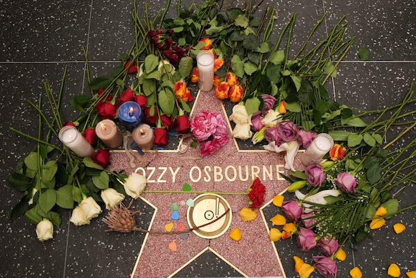 Flowers lie around the star for Ozzy Osbourne at the Hollywood Walk of Fame on Tuesday, July 22, 2025, in Los Angeles. (AP Photo/Damian Dovarganes)