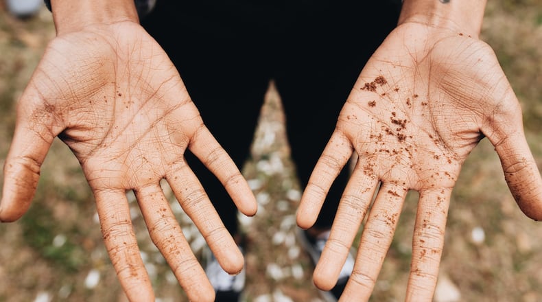 The hands of Kera Lamotte are shown after soil collection for Floyd Carmichael, who was reportedly shot to death by a mob without a trial after a white woman reported being assaulted, according to the Equal Justice Initiative. CONTRIBUTED BY REY GRANGER / FULTON COUNTY REMEMBRANCE COALITION