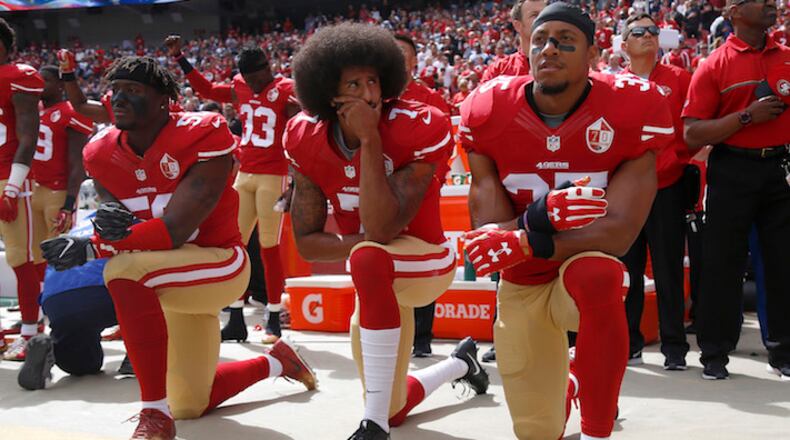 From left, the San Francisco 49ers' Eli Harold, Colin Kaepernick and Eric Reid kneel during the national anthem before their NFL game against the Dallas Cowboys on Oct. 2, 2016, at Levi's Stadium in Santa Clara, Calif. (Nhat V. Meyer/Bay Area News Group/TNS)