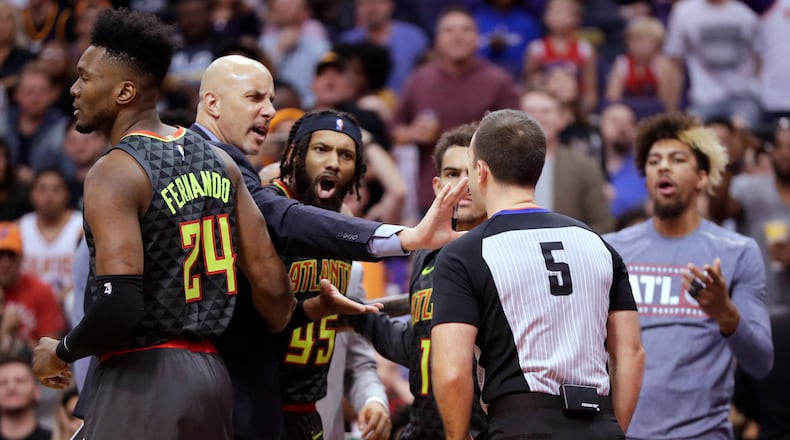 Referee Kane Fitzgerald ejects Hawks guard DeAndre' Bembry (middle) during the second half. (AP Photo/Matt York)
